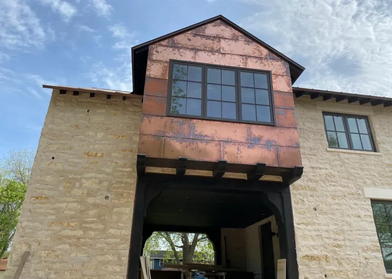 Copper metal panel facade on a stone building for Skylight Installation in Hallsville