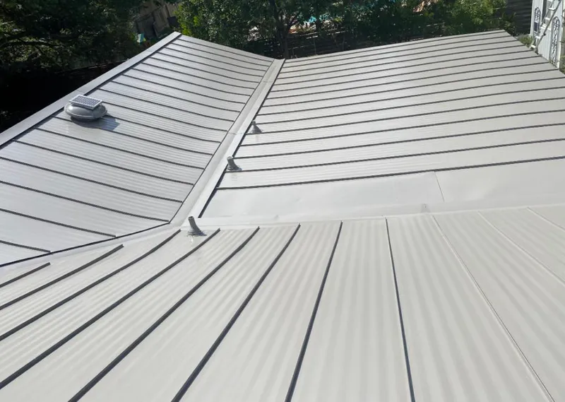 Solar attic fan installed on a metal roof for Roof Ventilation in Hallsville